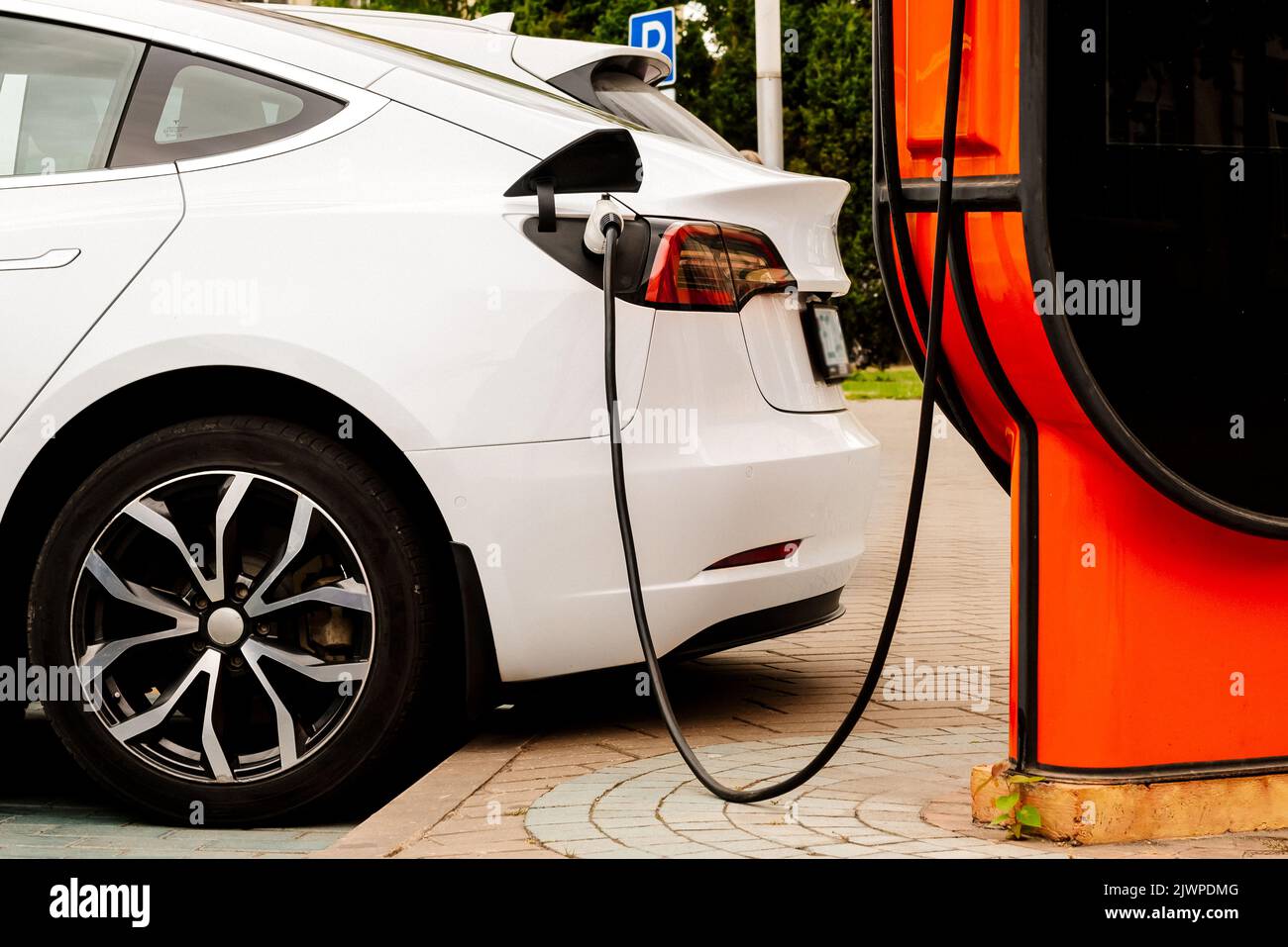 Electric car at the charging station. Ecology. Eco-friendly transport ...