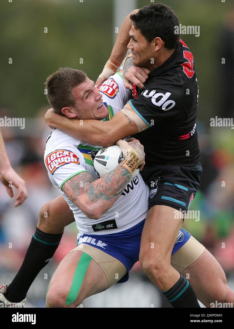 Josh Dugan tackled by Brad Tighe during the National Rugby League Round 23 match between Penrith Panthers V Canberra Raiders at the Centrebet Stadium on Sunday Aug 12th 2012