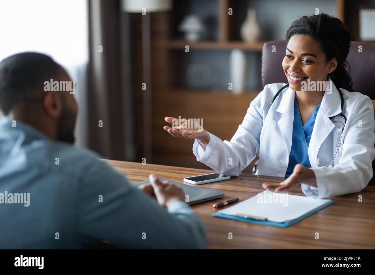 Friendly african american female doctor having conversation with ...