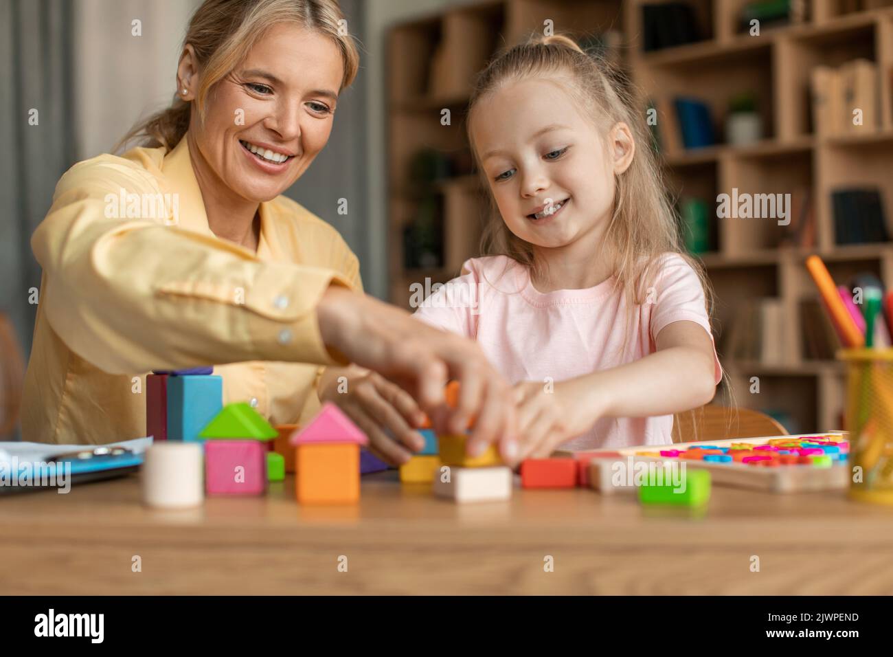 Games and education concept. Happy professional woman teacher