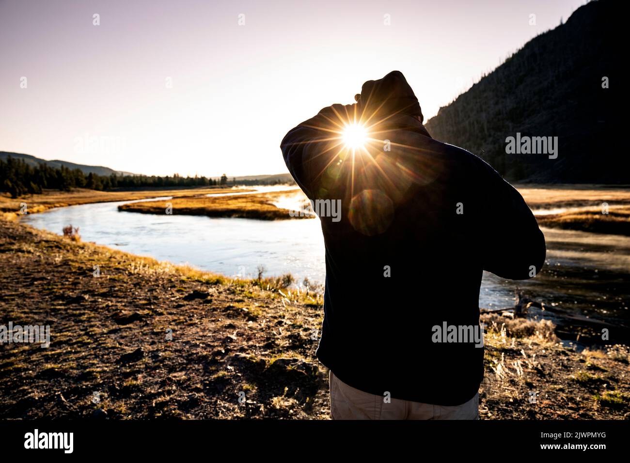 WY05030-00....WYOMING - Looking into the sunrise along the Madison River in Yellowstone National Park. Stock Photo