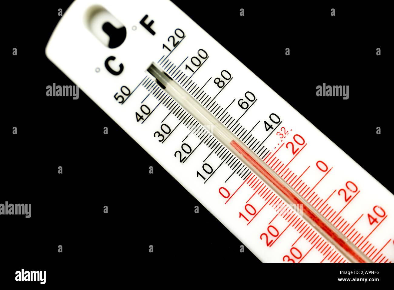 15 Celsius and almost 50 Fahrenheit degrees on a thermometer on black background Stock Photo