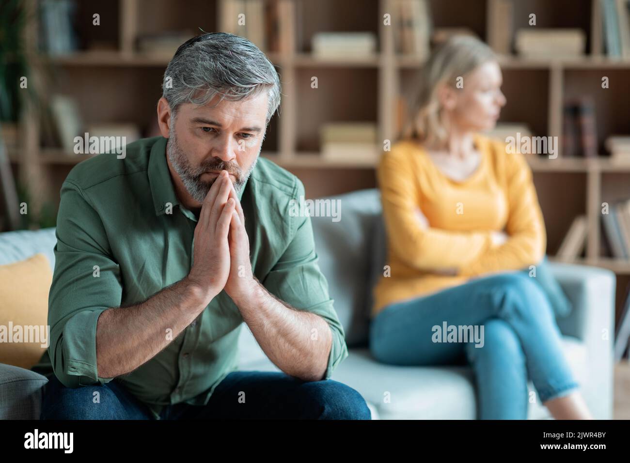 Marriage Problems. Middle Aged Wife And Husband Upset After Quarrel At Home Stock Photo