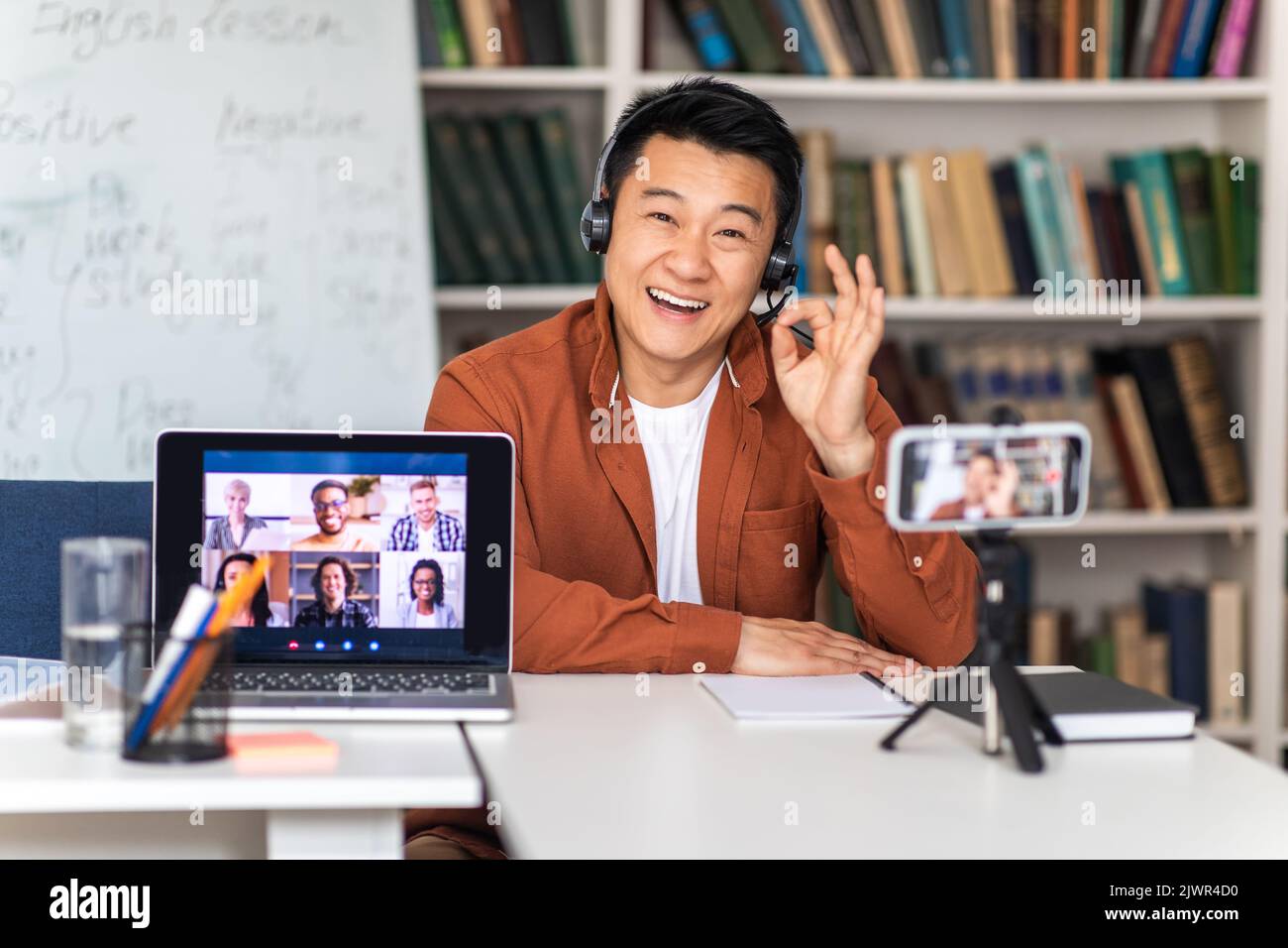 Asian Teacher Teaching Online Gesturing Okay Having Video Call Indoor Stock Photo