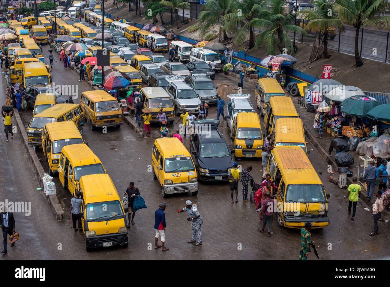 People going about their daily activity seen at a busy bus park in