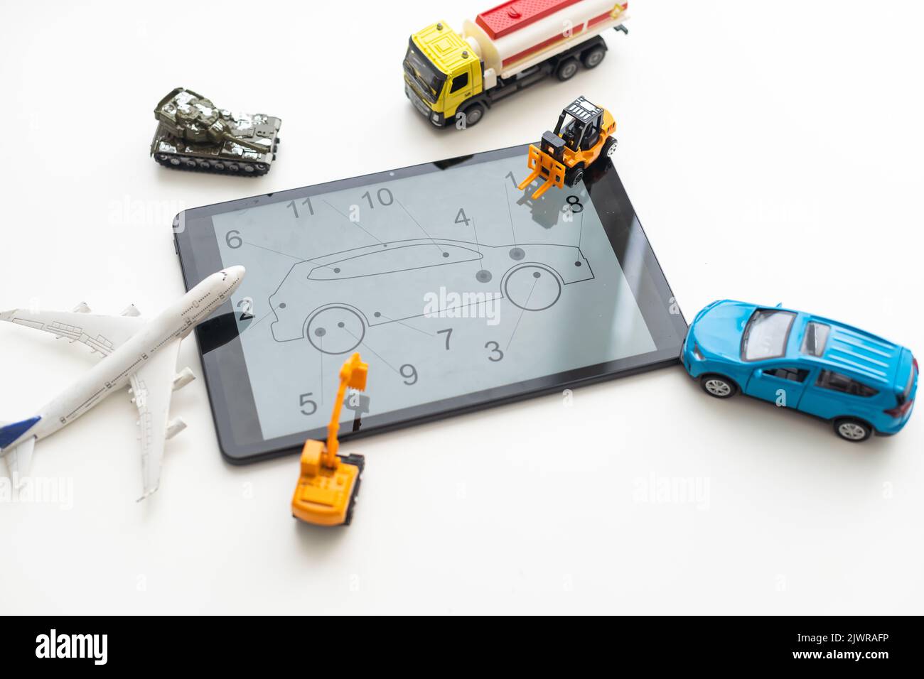 Tablet computer with different types of toy transport Stock Photo