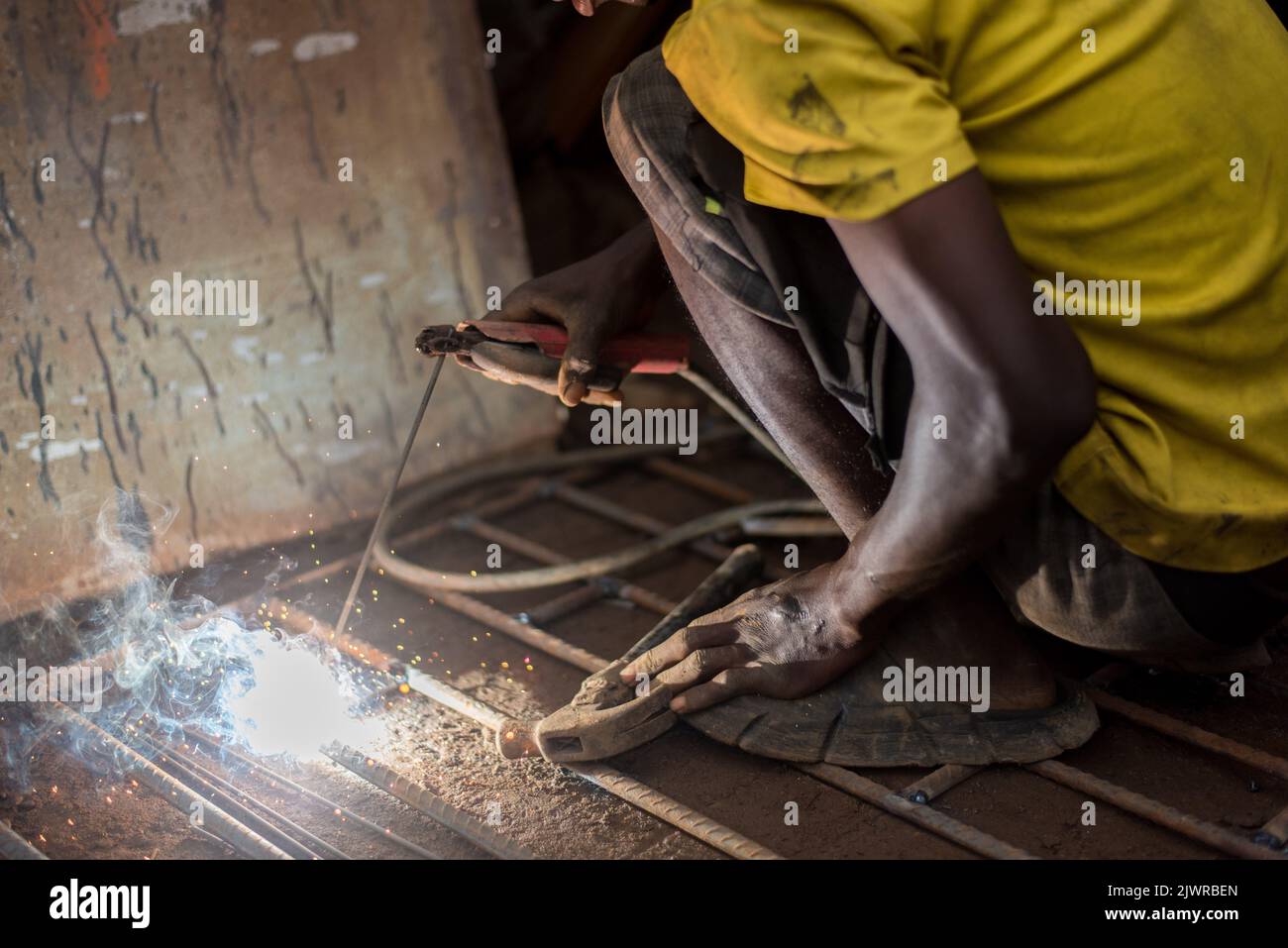 Man at work. A young welder observered at work in Lagos, NIGERIA, on