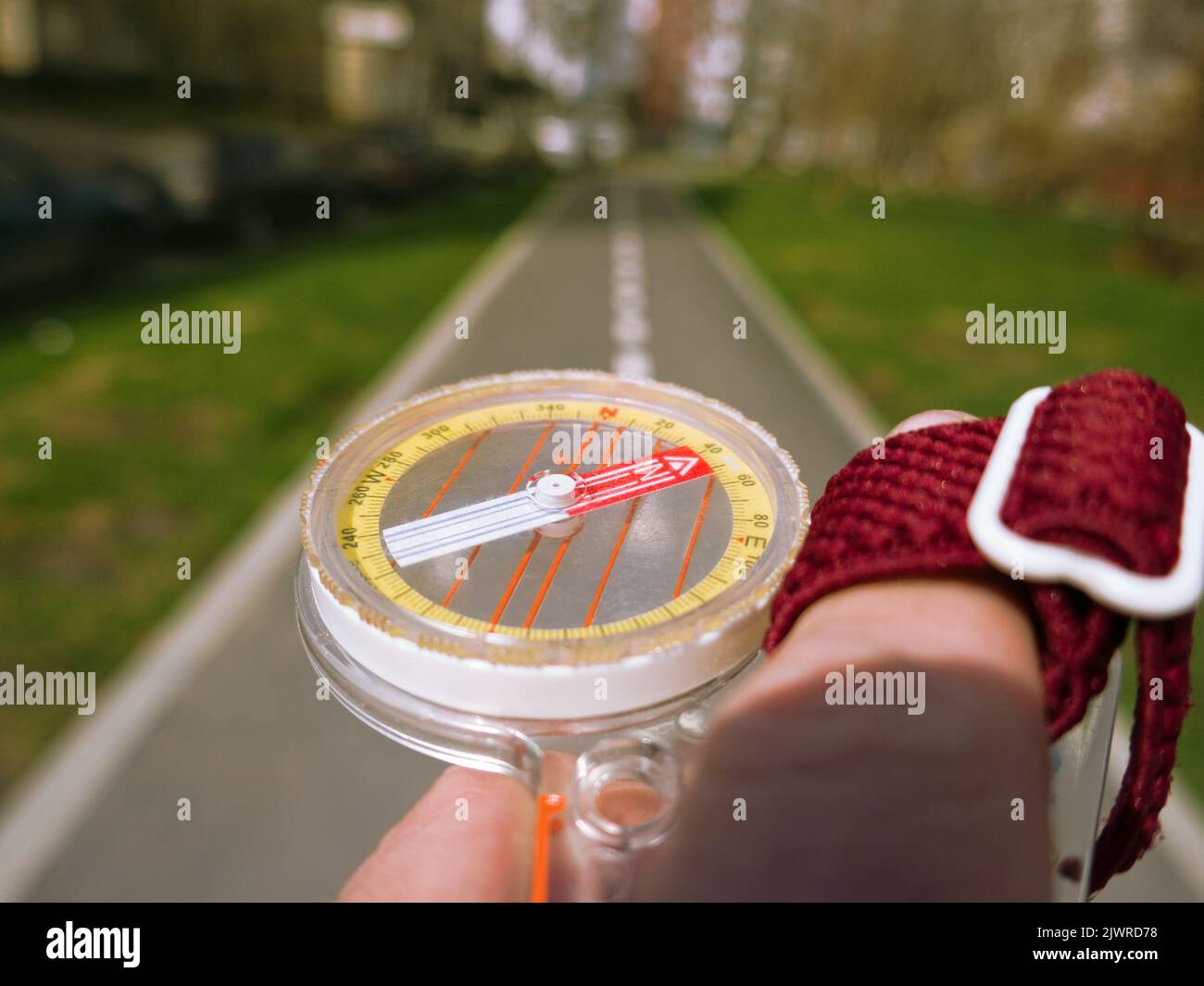 A compass in a person's hand. Orient yourself in the current situation