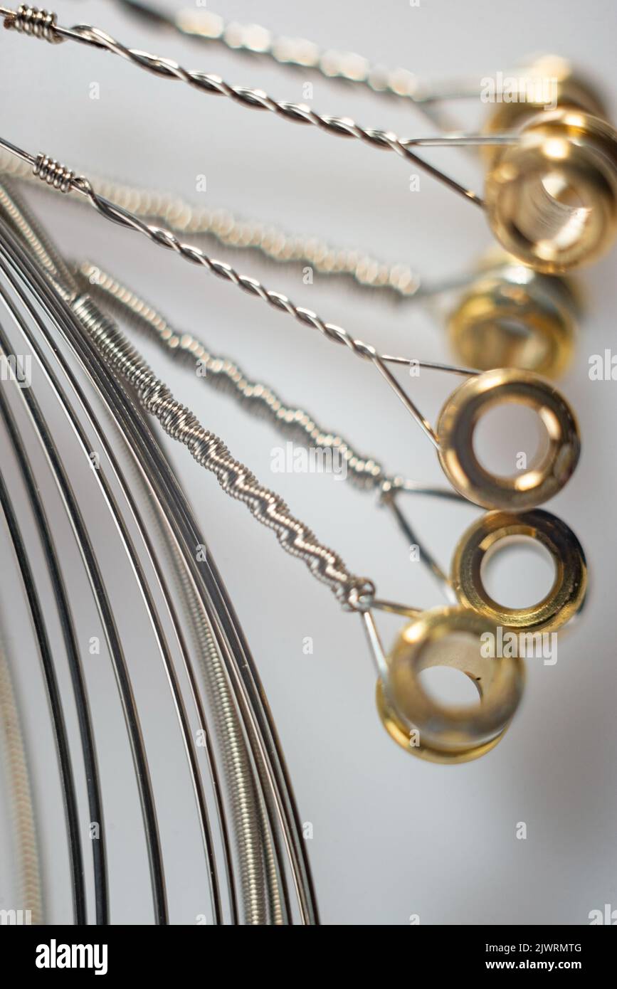 macro details of strings for electric guitar on a white background. Stock Photo