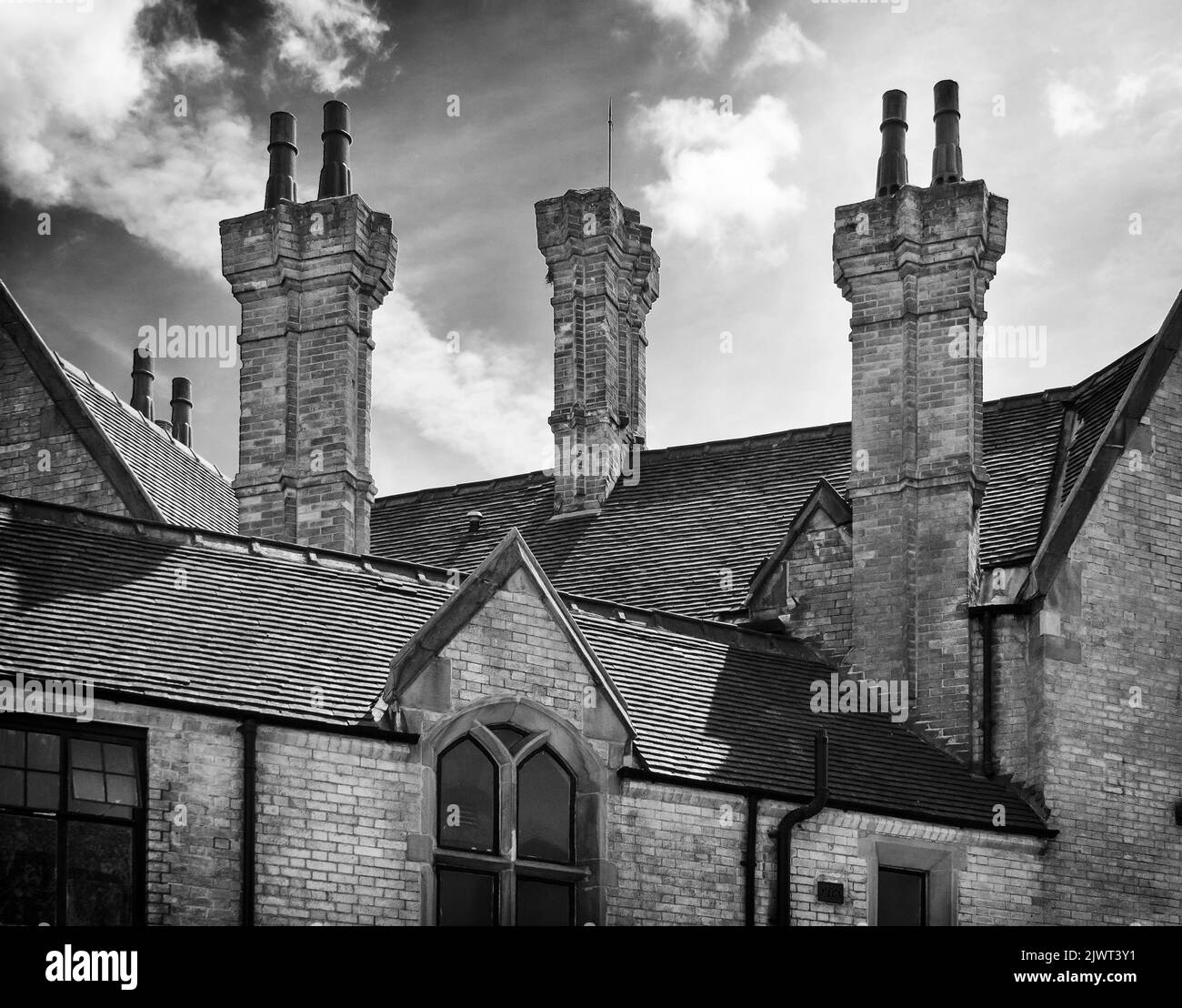 Chimneys on a historic roofline in Stoke on Trent. A luminous cloud pattern adds to the scene Stock Photo