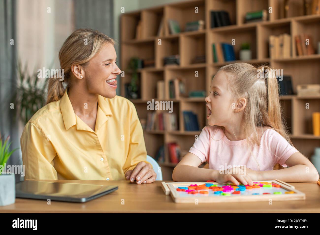Speech training for kids. Professional female specialist training with