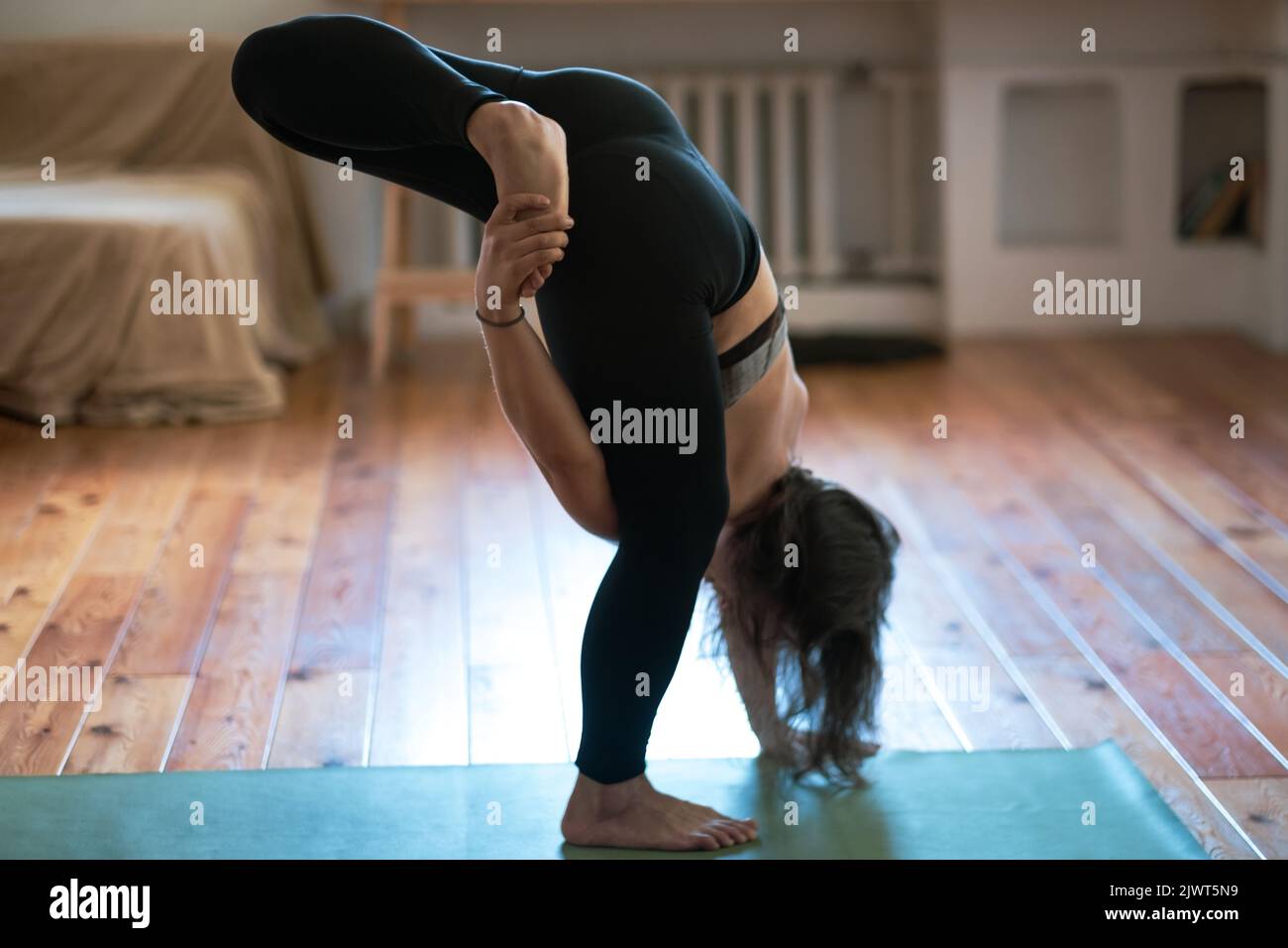 Caucasian woman practicing yoga lesson, doing stretcing exercise, working out, indoor close up. Well being, wellness concept Stock Photo