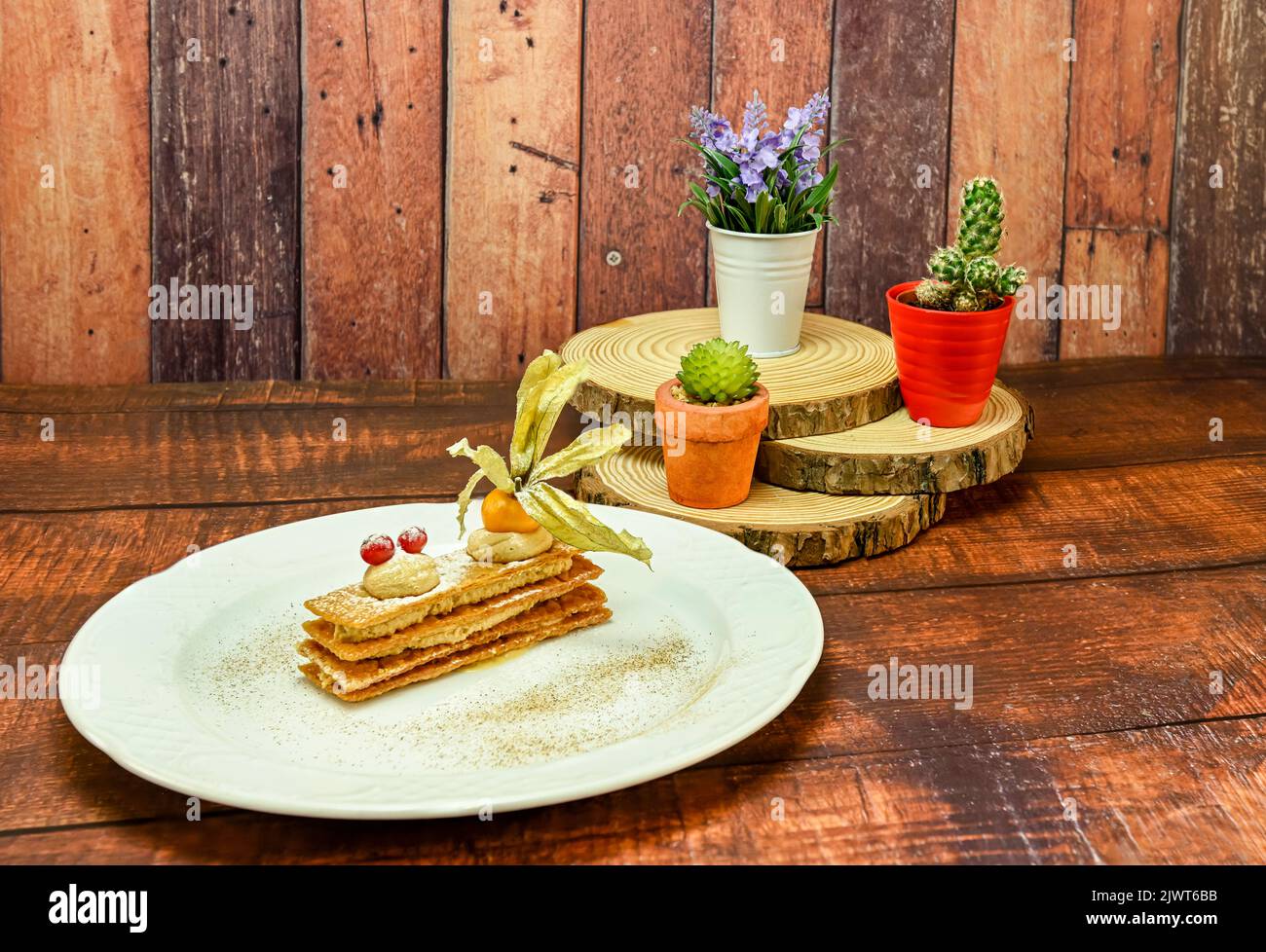 Crunchy inverted puff pastry mille-feuille with caramel and toffee mousse. Stock Photo