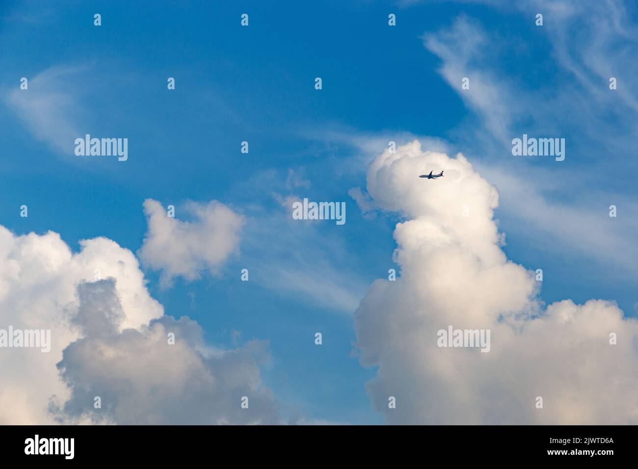 Blue sky with clouds and airplane Stock Photo - Alamy