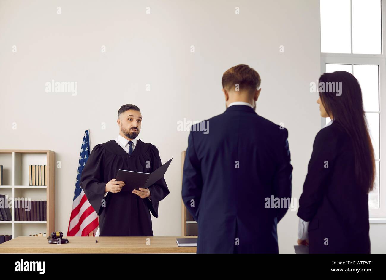 Judge in American courthouse gives judgment and enforces punishment on young man Stock Photo