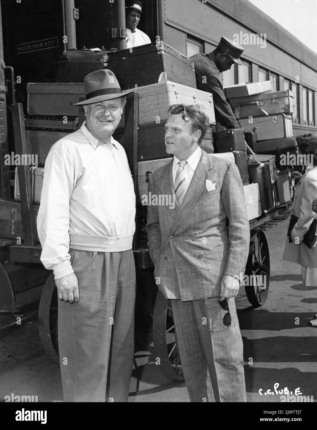 ALAN HALE and JAMES CAGNEY on arrival at Pasadena train station after one month location trip in Canada filming CAPTAINS OF THE CLOUDS 1942 director MICHAEL CURTIZ music Max Steiner associate producer William Cagney Warner Bros. Stock Photo