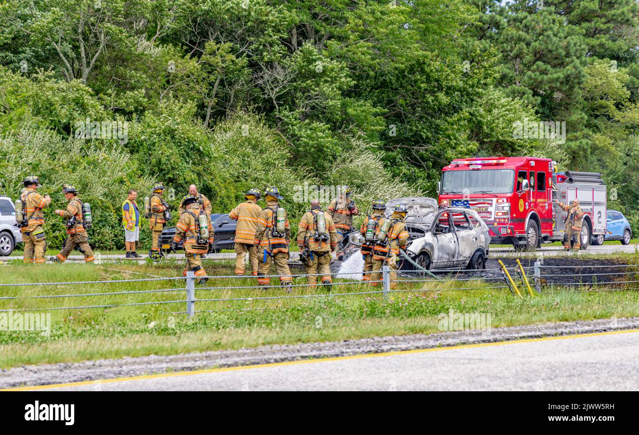Fireman at a car fire on 495 on Long Island, NY Stock Photo