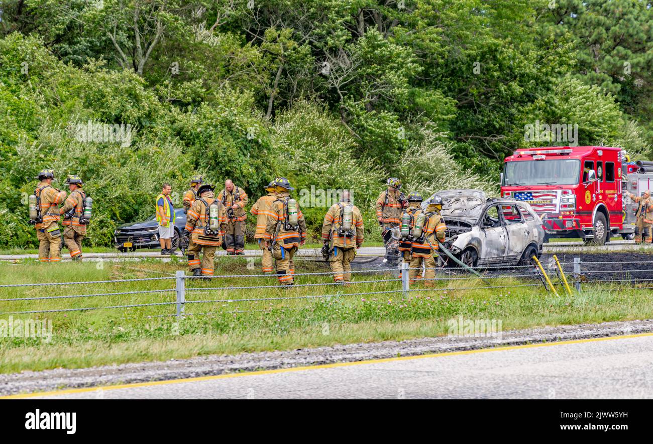 Fireman at a car fire on 495 on Long Island, NY Stock Photo