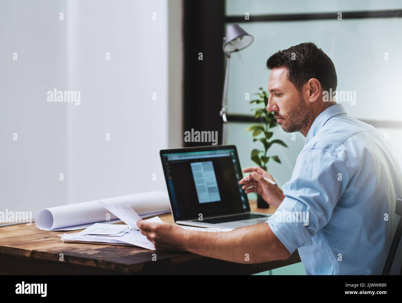 Putting in the hard work at home. a businessman working on his laptop at home. Stock Photo