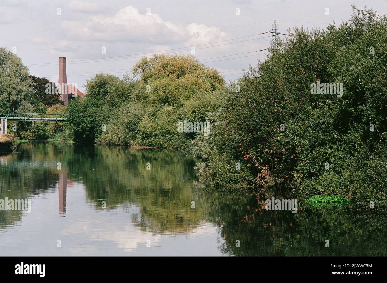 The River Lea Navigation at Walthamstow Wetlands in summertime, with the Engine House building in the background Stock Photo
