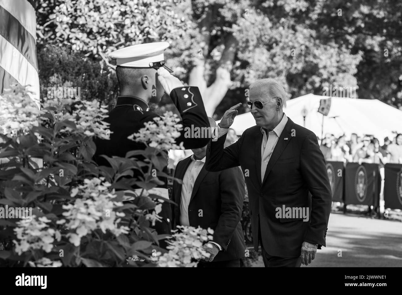 President Joe Biden salutes a Marine sentry Monday, July 4, 2022, as he