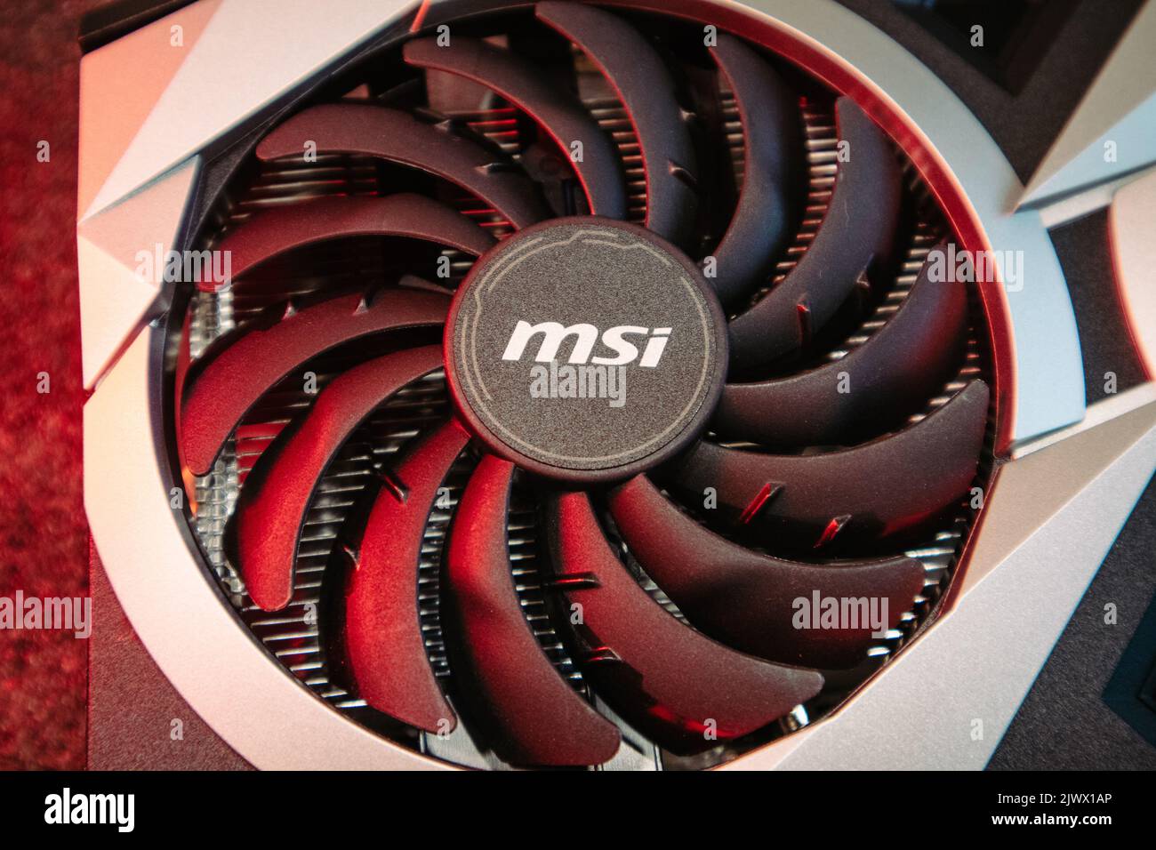 Kyiv, Ukraine - August 19, 2022: Cooler in red light, MSI graphics card with AMD Radeon chipset, close-up with selective focus, PC equipment details Stock Photo