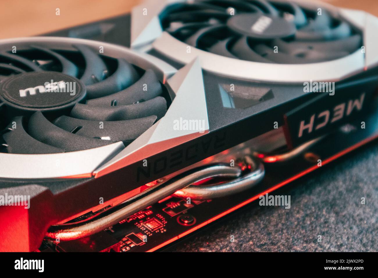 Kyiv, Ukraine - August 19, 2022: MSI MECH 2X graphics card with AMD Radeon chipset in red light, PC hardware details close-up Stock Photo