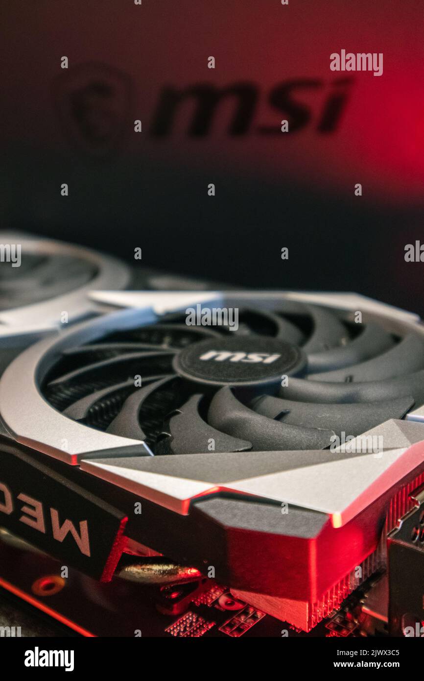 Kyiv, Ukraine - August 19, 2022: MSI MECH 2X graphics card with AMD Radeon RX6700XT chipset in red light, close-up with selective focus, PC equipment Stock Photo
