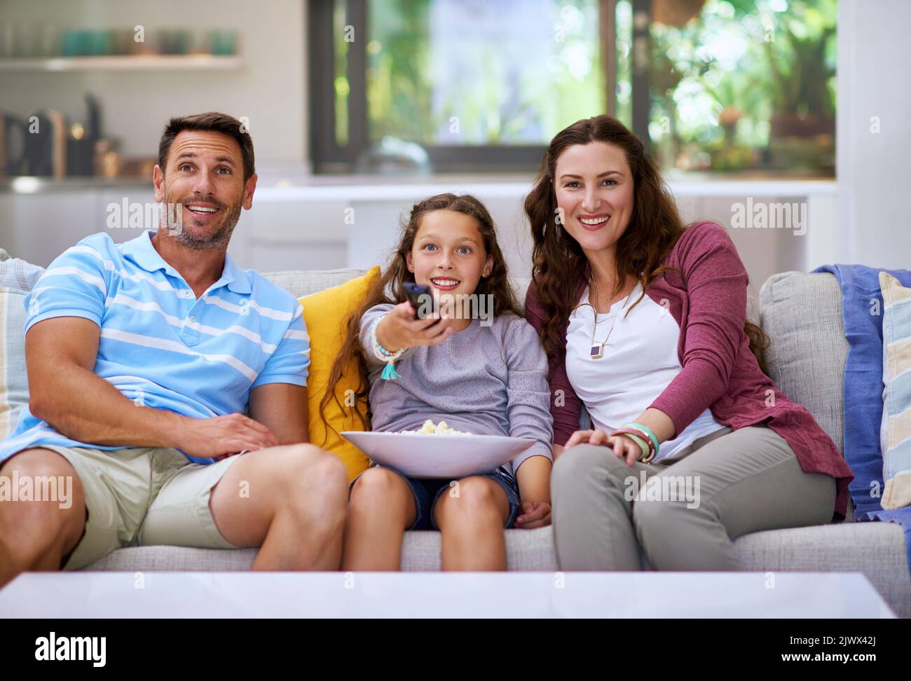 My choice of movie tonight. a family watching a movie on the sofa. Stock Photo