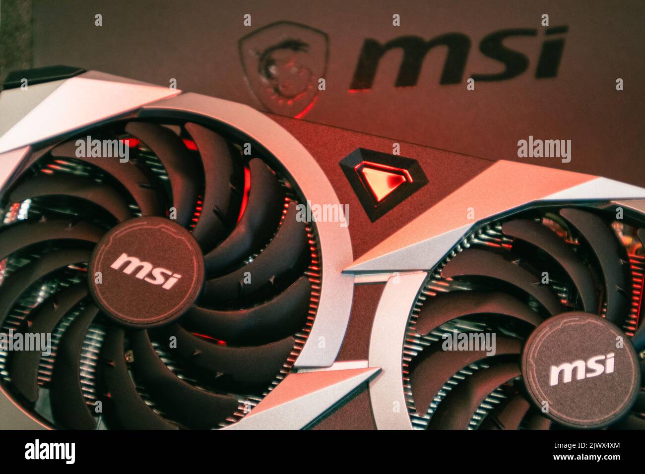 Kyiv, Ukraine - August 19, 2022: MSI MECH 2X graphics card with AMD Radeon RX6700XT chipset in red light, close-up with selective focus Stock Photo