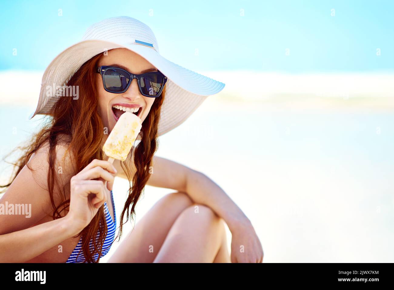 I love ice cream-filled summers. Portrait of a beautiful young woman ...