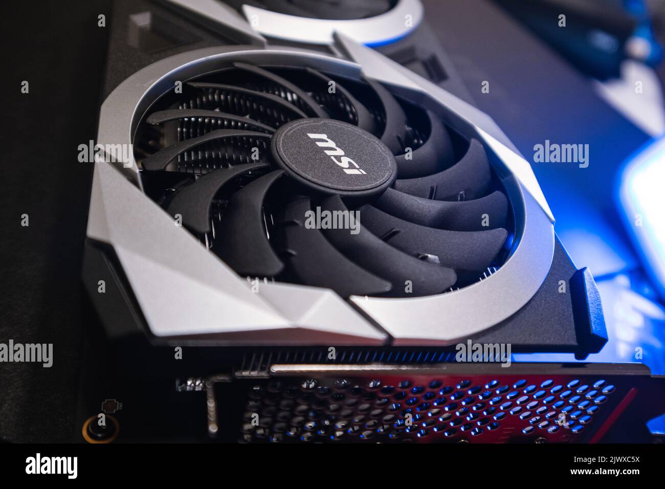 Kyiv, Ukraine - August 19, 2022: Cooler in blue light, MSI graphics card with AMD Radeon chipset, close-up with selective focus, dark design Stock Photo