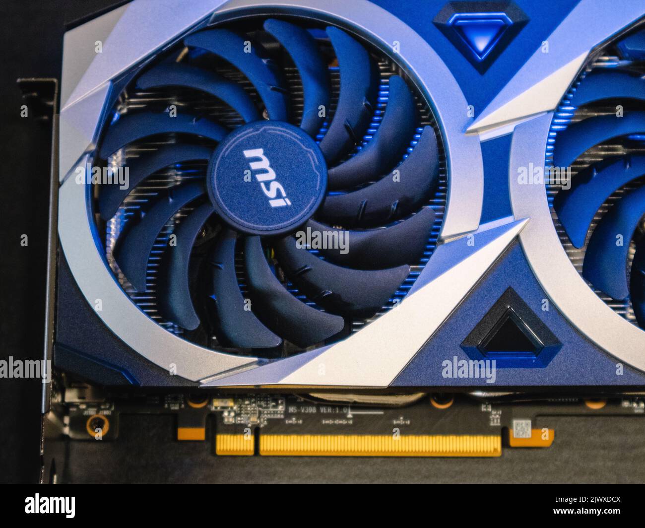 Kyiv, Ukraine - August 19, 2022: MSI MECH 2X graphics video card cooler close-up in blue light, computer components details top view with selective fo Stock Photo