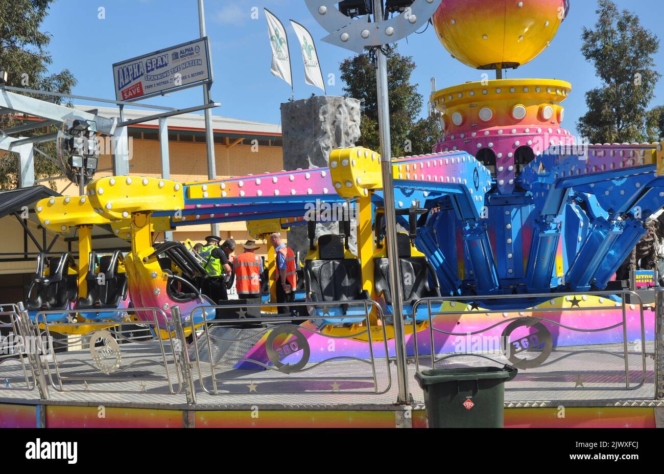 Police and safety officers inspect the Airmaxx 360 ride at the Royal Adelaide Show in Adelaide Friday Sept. 12 2014. An eight year old girl has died after being thrown from a ride about