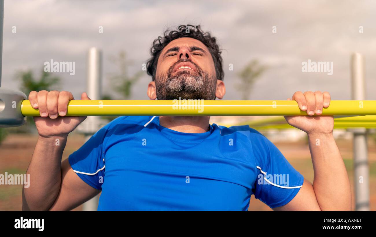 Male pull up workout steps. Caucasian man hanging on a bar to working ...