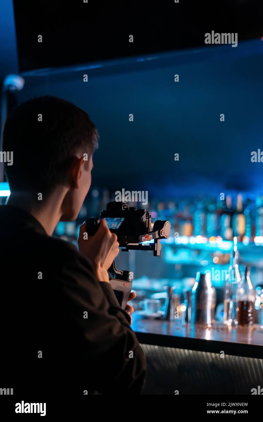 professional videographer operator shooting video with handheld gimbal, camera Stock Photo