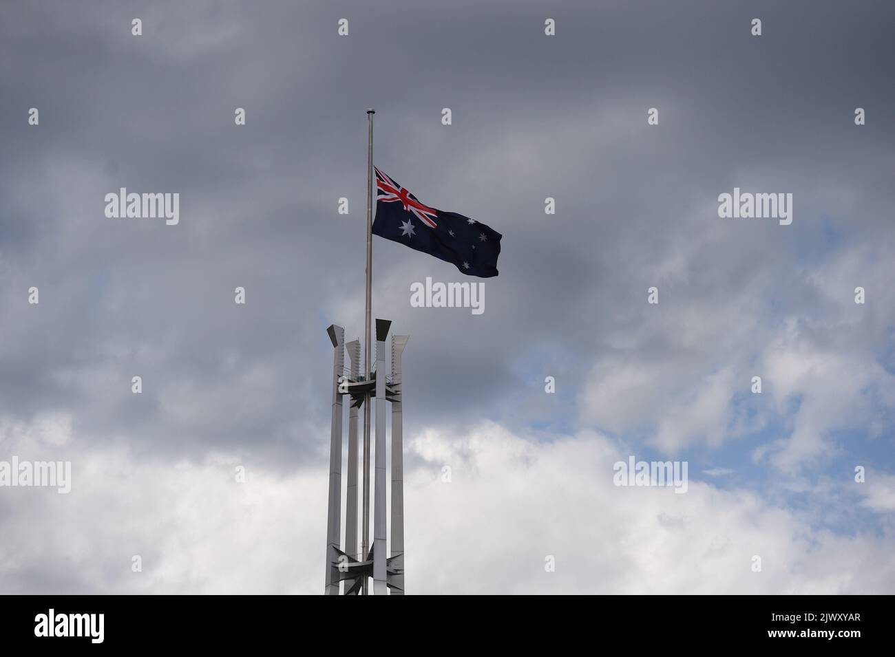 The Australian National flag is seen flying halfmast at Parliament