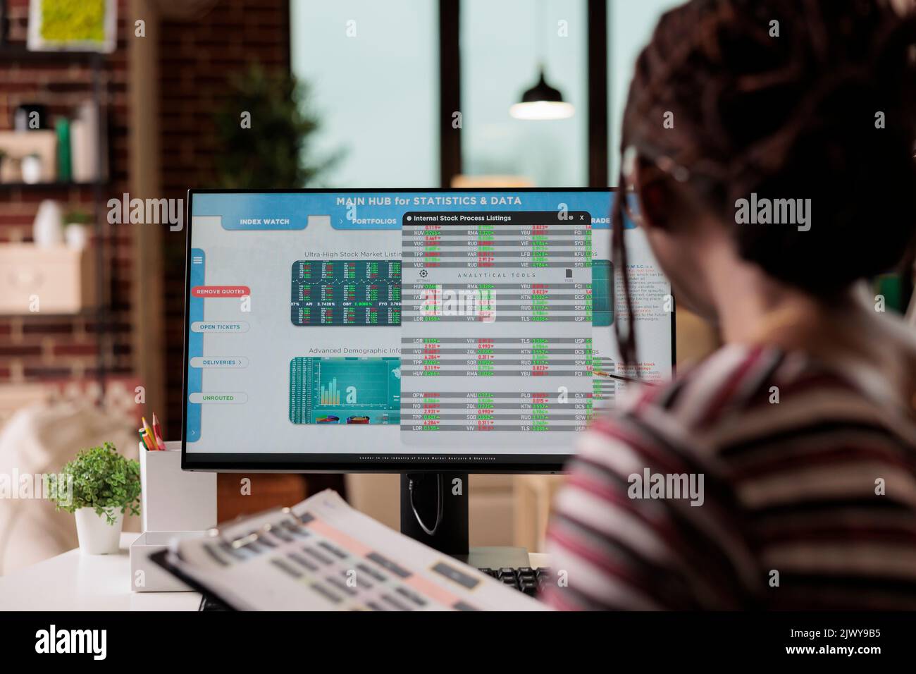 Woman working with internet of things, looking at data on computer screen, analyzing statistics. Web3, iot technology, web based online application for work, business innovation concept Stock Photo