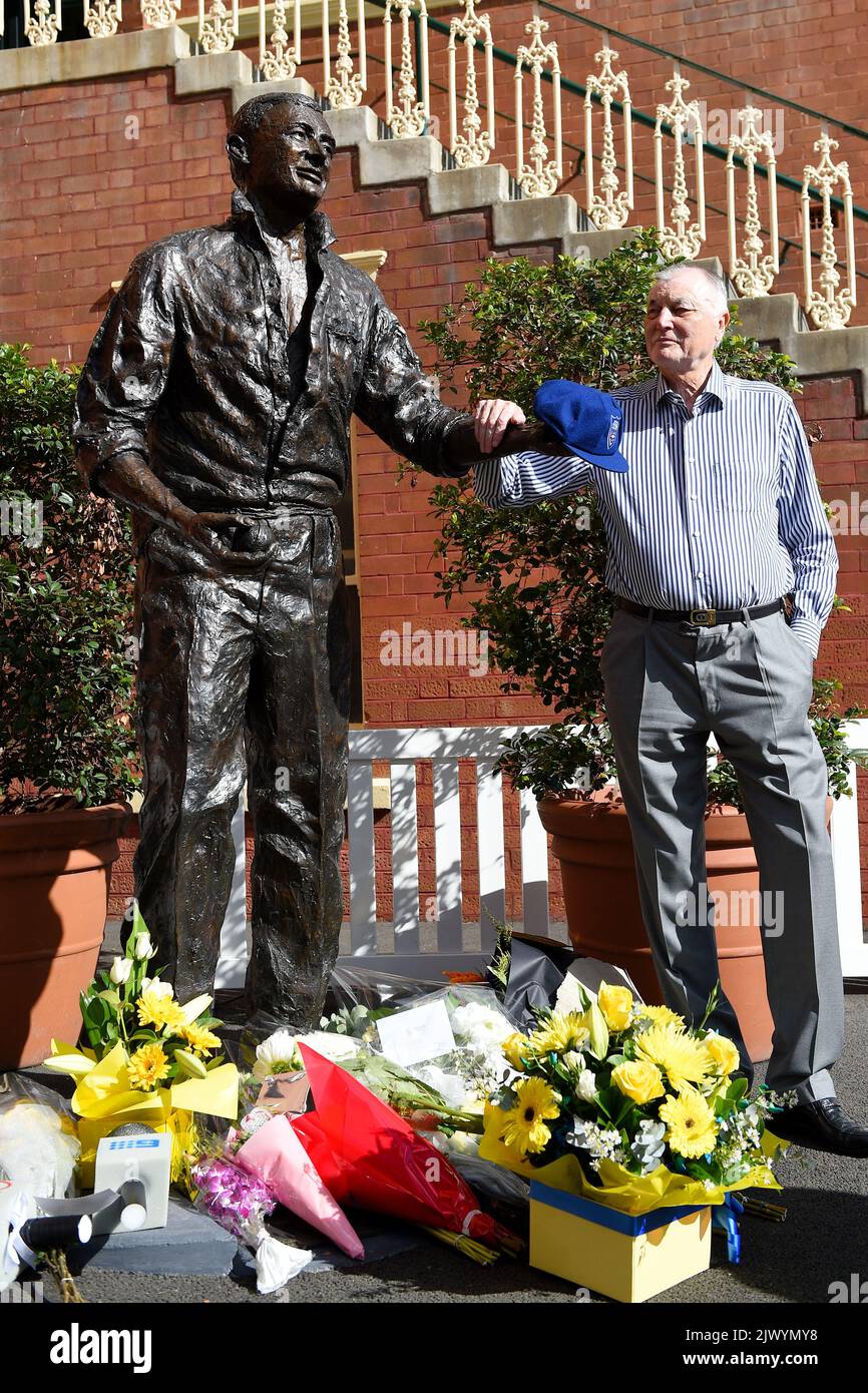 Basil Sellers pays his respects at a floral tribute at the bronze statue of Australian test