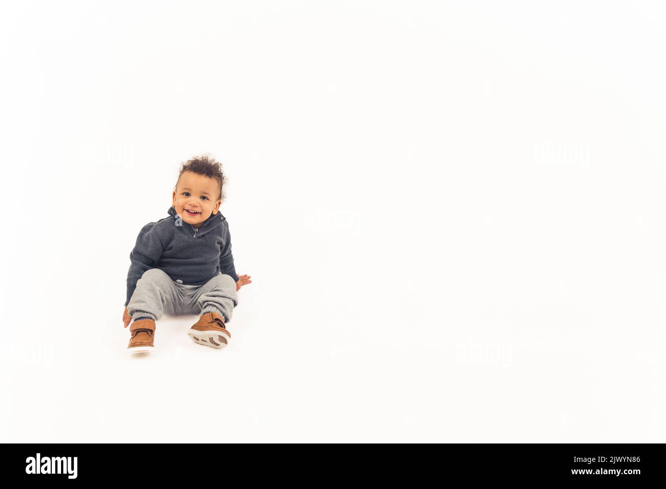 cute Afro-American little boy with a fake mustache, medium closeup studio shot isolated. High quality 4k footage Stock Photo