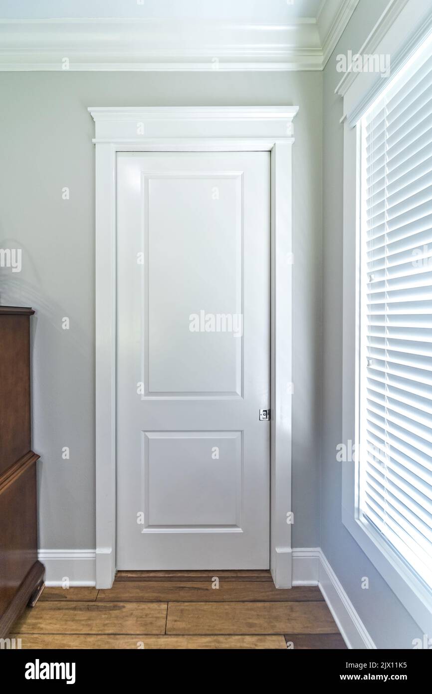 a bathroom or closet closed white door in a new construction house. Stock Photo