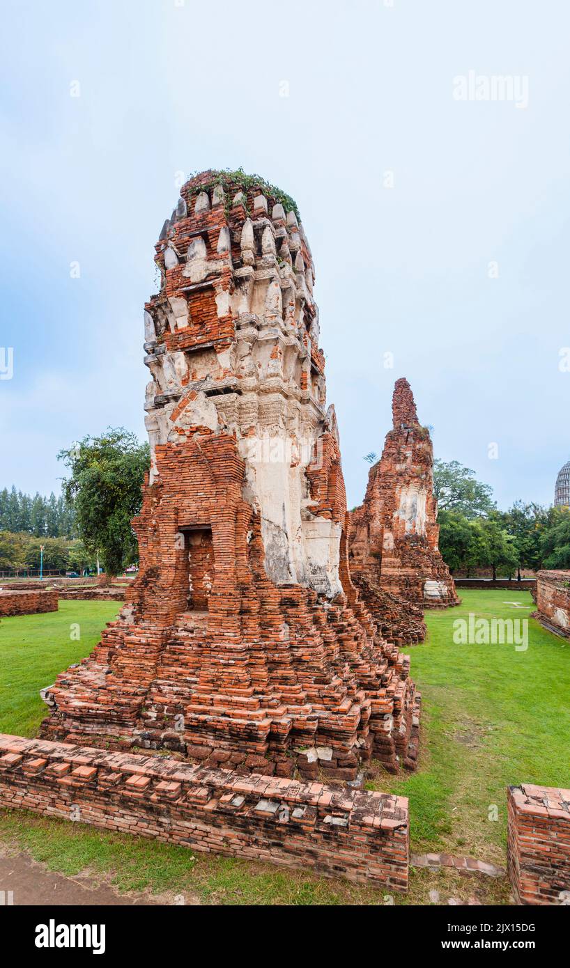 Dilapidated, crumbling red brick prangs in the ruins at Wat Maha That, the sacred royal temple in Ayutthaya, Thailand Stock Photo