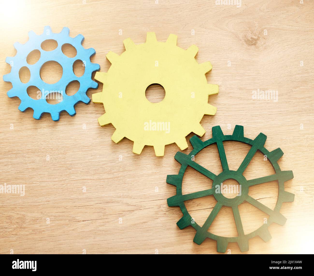 Settings gear icon, abstract and illustration of cog wheel against a wooden background. Innovation, development and mechanical logo. Setup, engine and Stock Photo