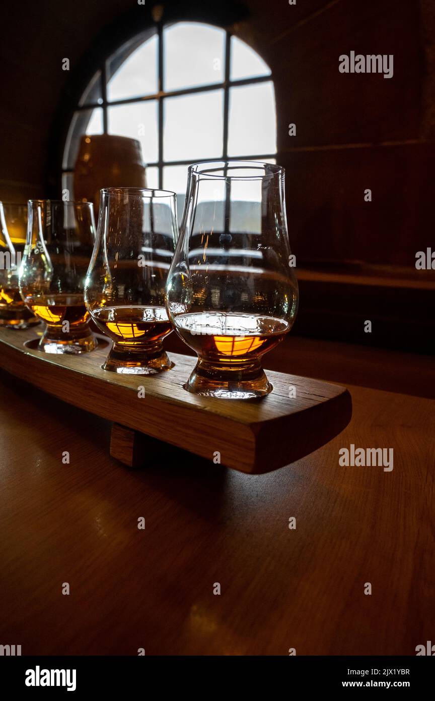 Flight of single malt scotch whisky in glasses served in bar in
