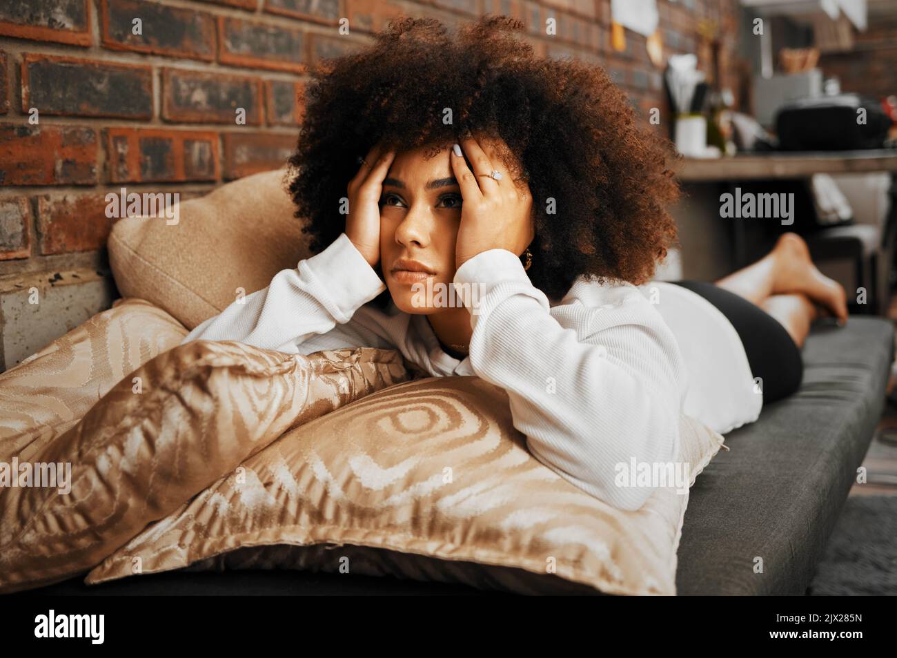 Depressed, sad and frustrated African woman thinking of idea with