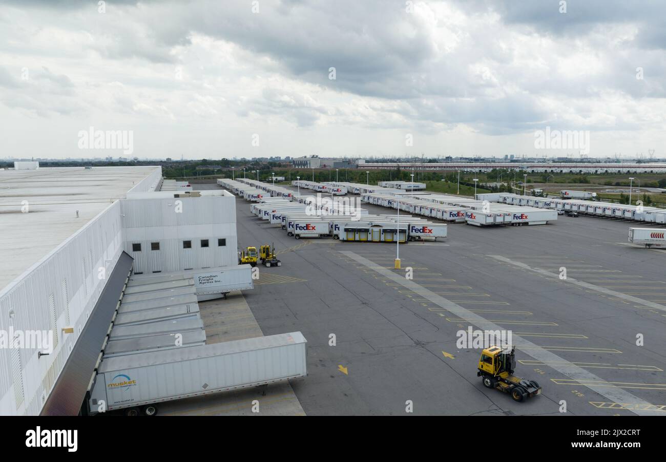 An aerial photo above a FedEx, Federal Express, shipping center with a number of FedEx transport trailers seen parked. Stock Photo