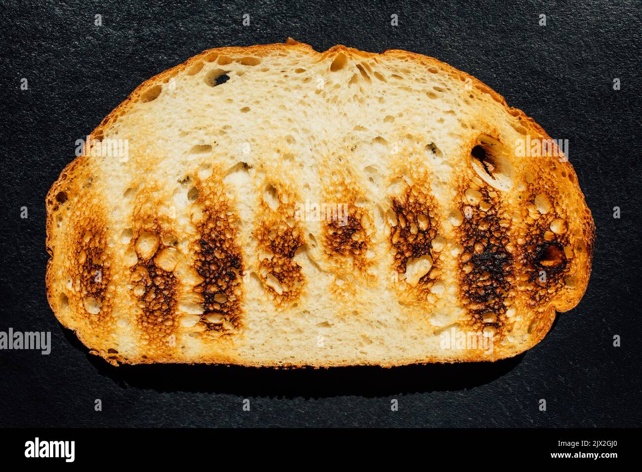 grilled, toasted sourdough bread on dark background Stock Photo Alamy