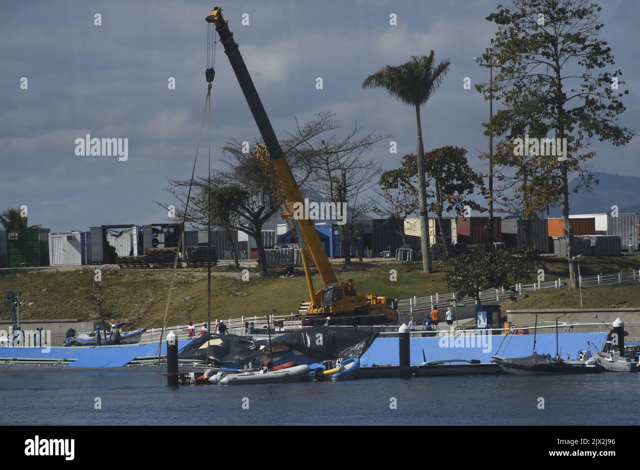 Construction workers are seen repairing a broken boat ramp at the ...