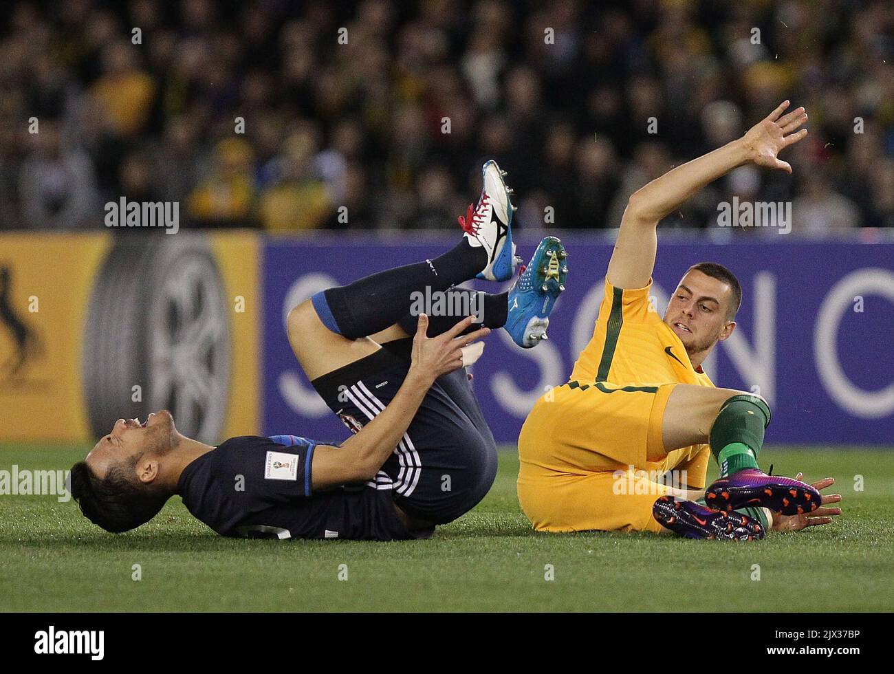 Maya Yosida of Japan reacts after being kicked by Tomi Juric of Australia during the 2018 FIFA World Cup Qualifier game at Etihad Stadium in Melbourne, Tuesday, Oct. 11, 2016. (AAP Image/Stefan Postles)  Stock Photo