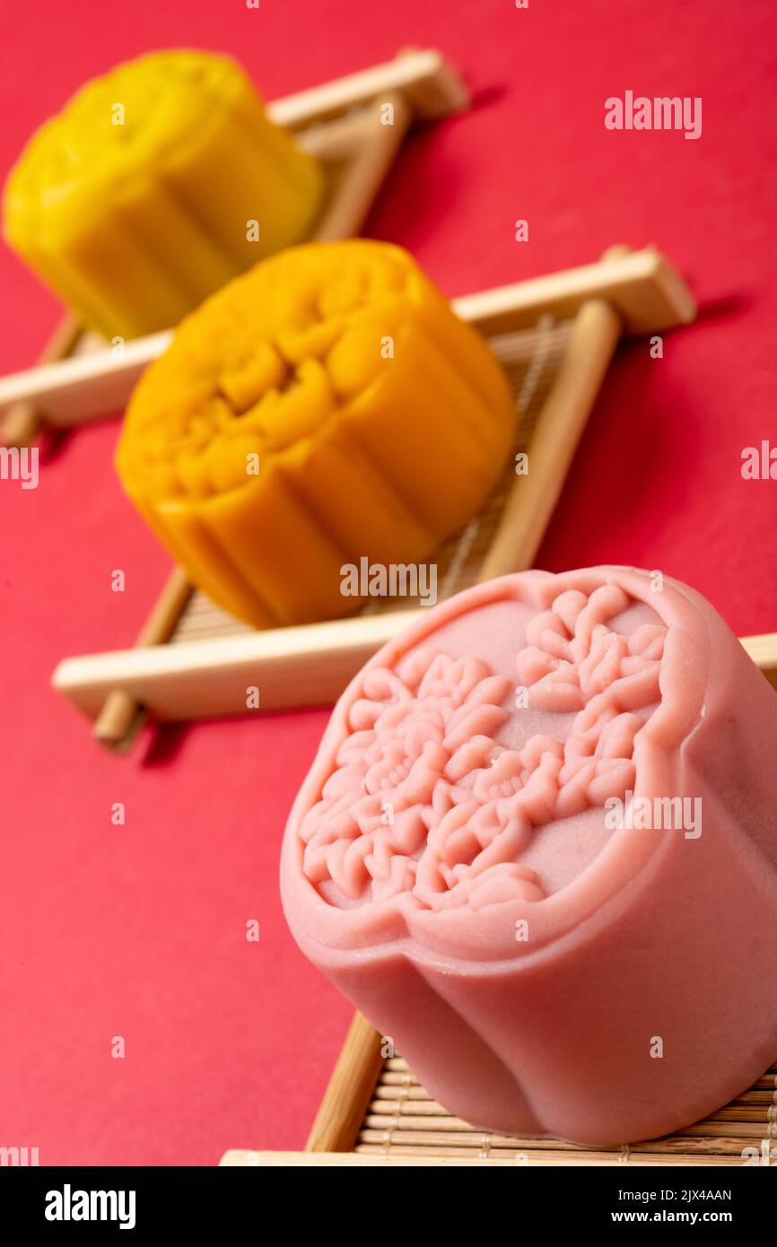 trendy flower shape mooncake on red background at vertical composition Stock Photo